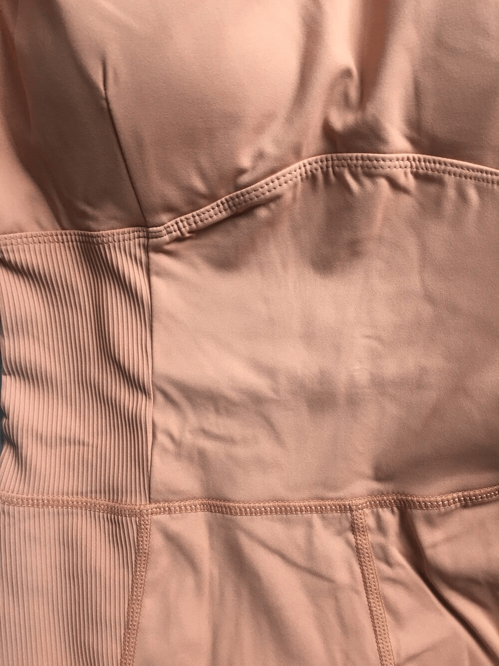 Close-up of sexy women's one-piece elastic yoga jumpsuit in solid color, highlighting the breathable and stretchy material for sports.